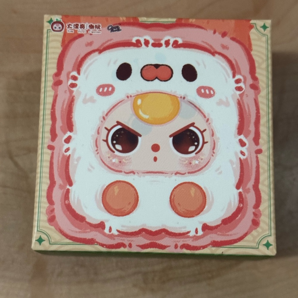 Source Unknown Pink White and Orange Plush Character Box Art